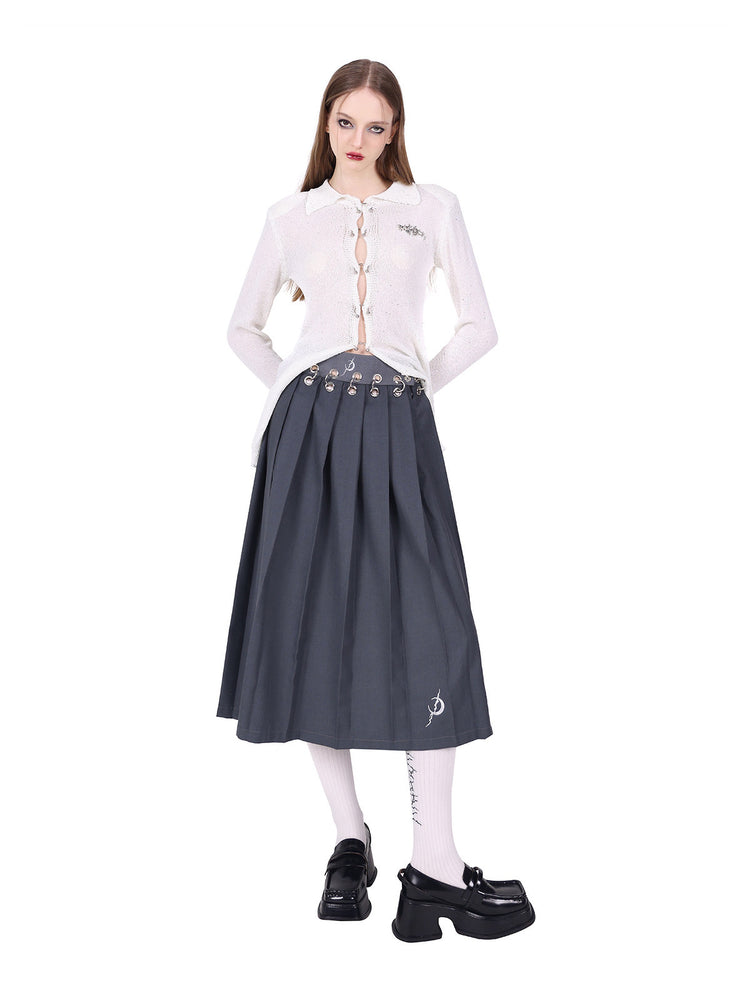 PINKSPINK ELECTRIC MOON ring-fastened sequin knit shirt in white — angled front pose with one side tucked into a pleated skirt