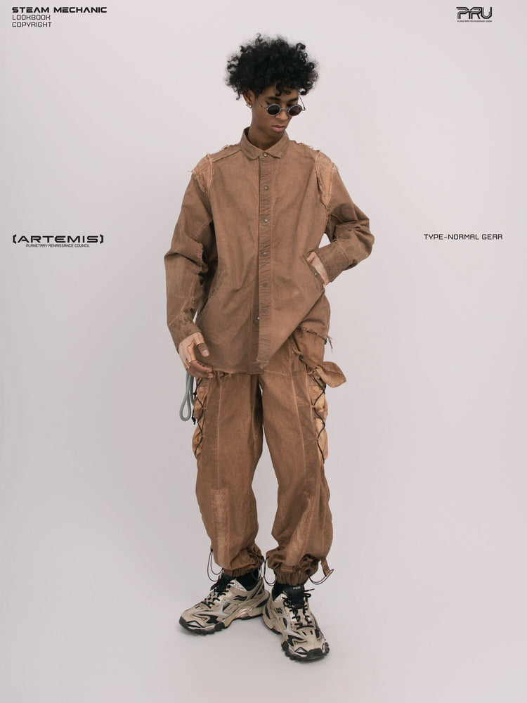CHAOS ERA raw-edge technical shirt in soft dawn orange — full-length front modeled view with one hand at the hip