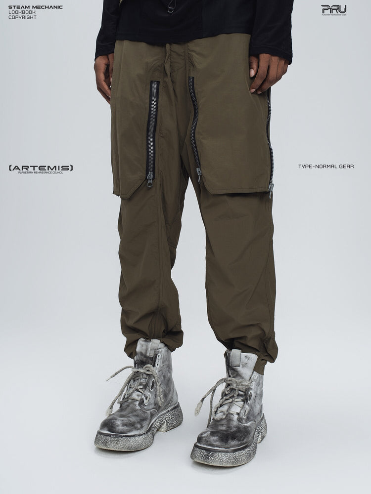 GAIA curved-blade technical pants in mountain green — opposite three-quarter modeled view with front covers closed