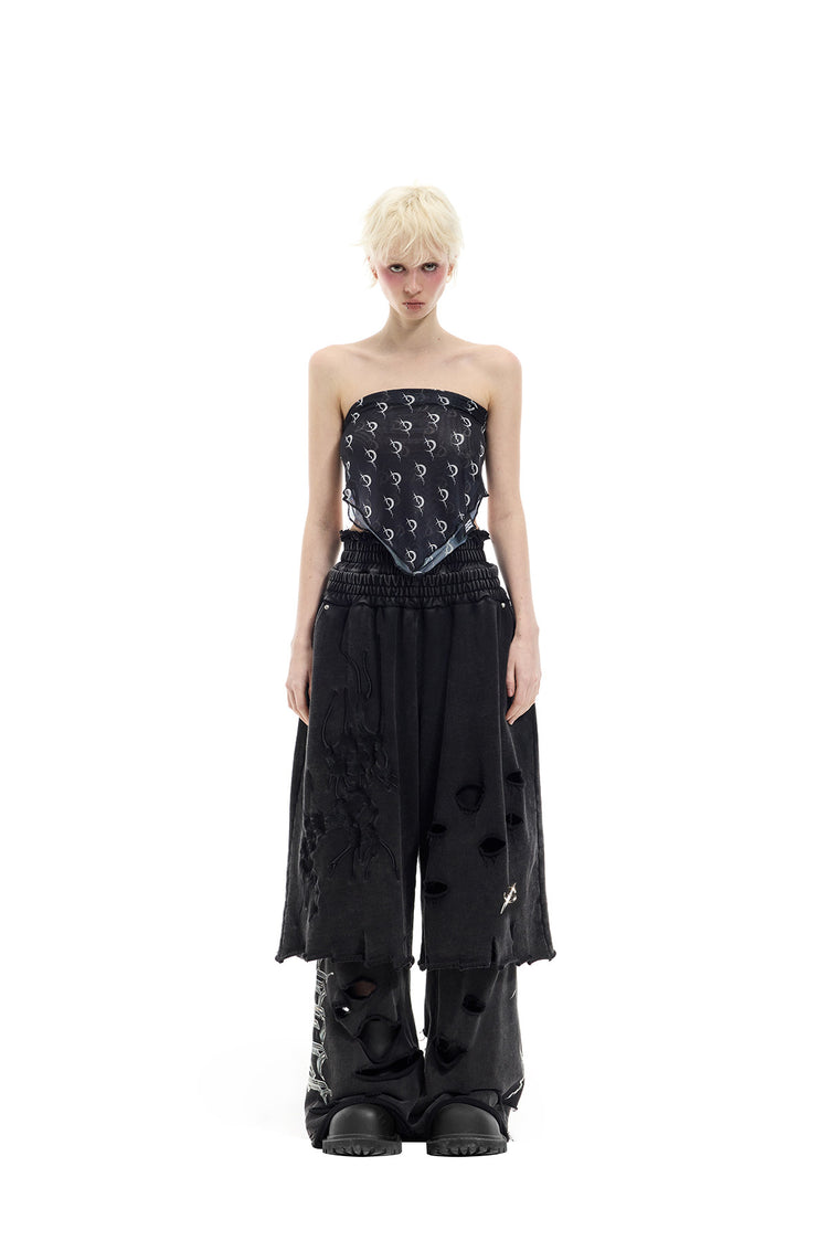 PINKSPINK ELECTRIC MOON distressed embroidered wide-leg shorts — black — full-length front view layered over trousers