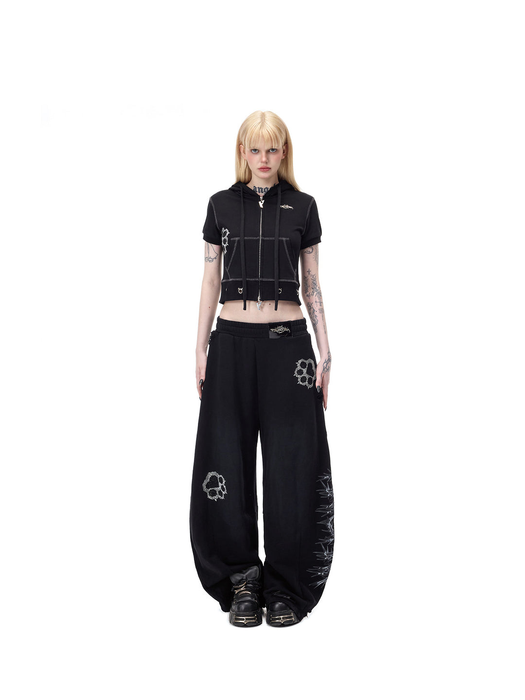 PINKSPINK CATPAW rhinestone curved-leg sweatpants in black — centered full-length front modeled view repeated in the hero collage