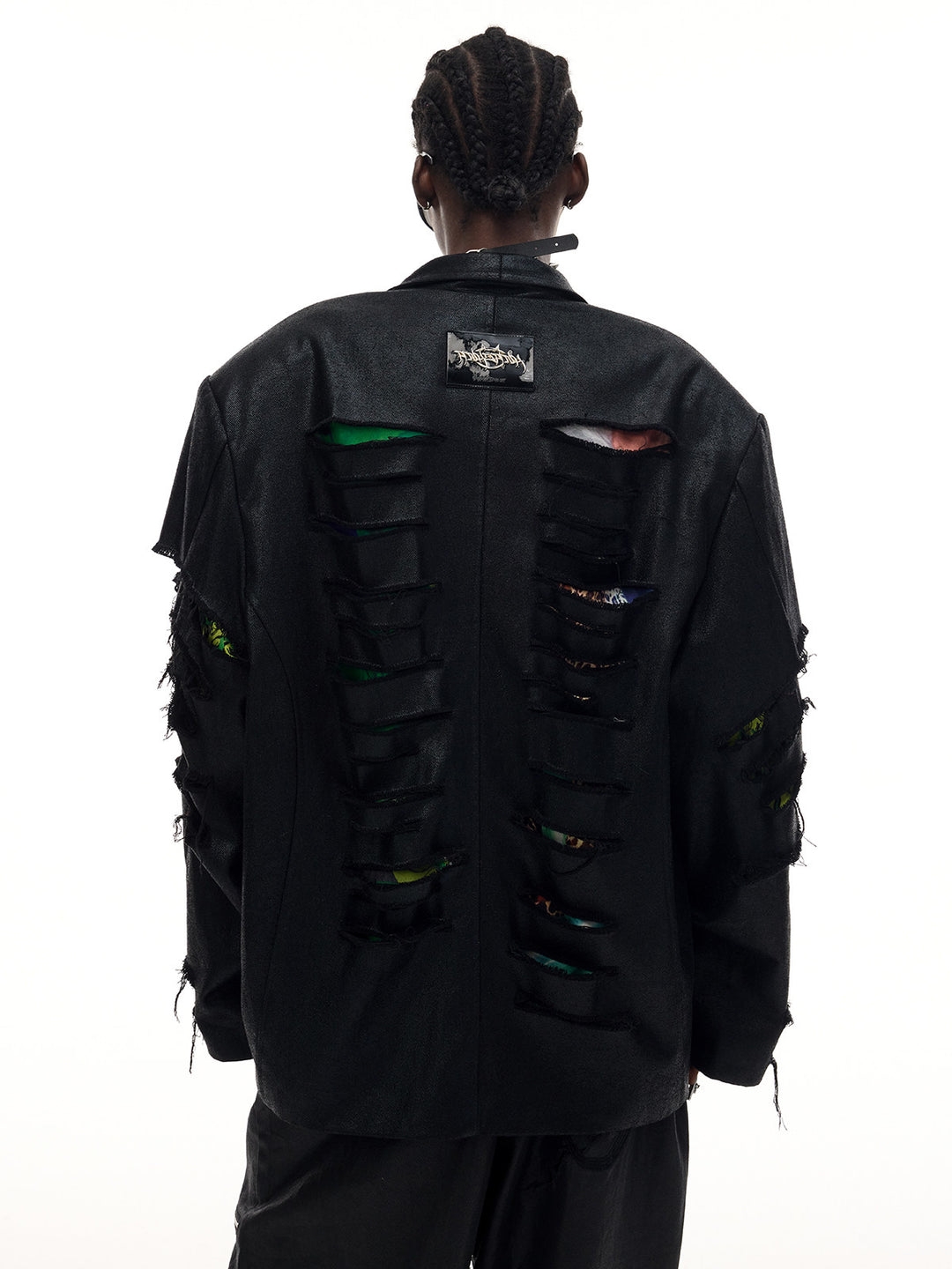 PINKSPINK BREACH distressed coated oversized blazer in black — close rear modeled view showing the symmetrical rows of slashes