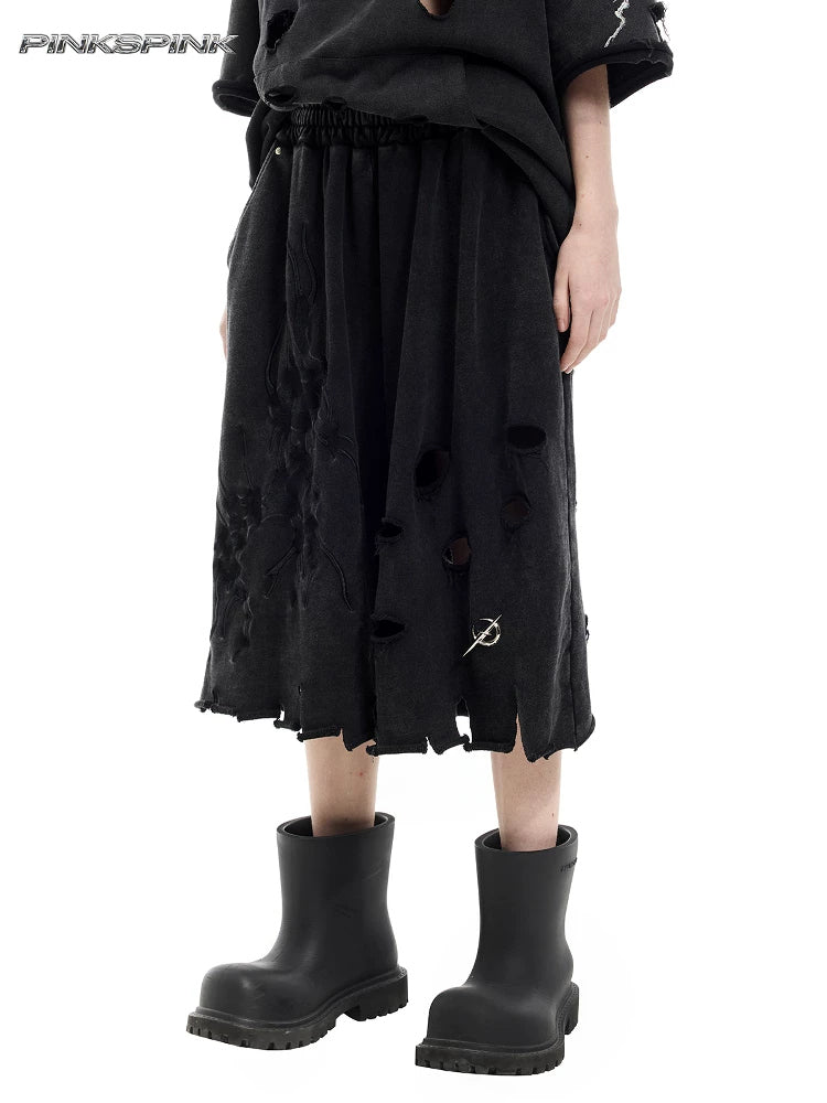 PINKSPINK ELECTRIC MOON distressed embroidered wide-leg shorts — black — three-quarter close-up of the embroidered wide legs