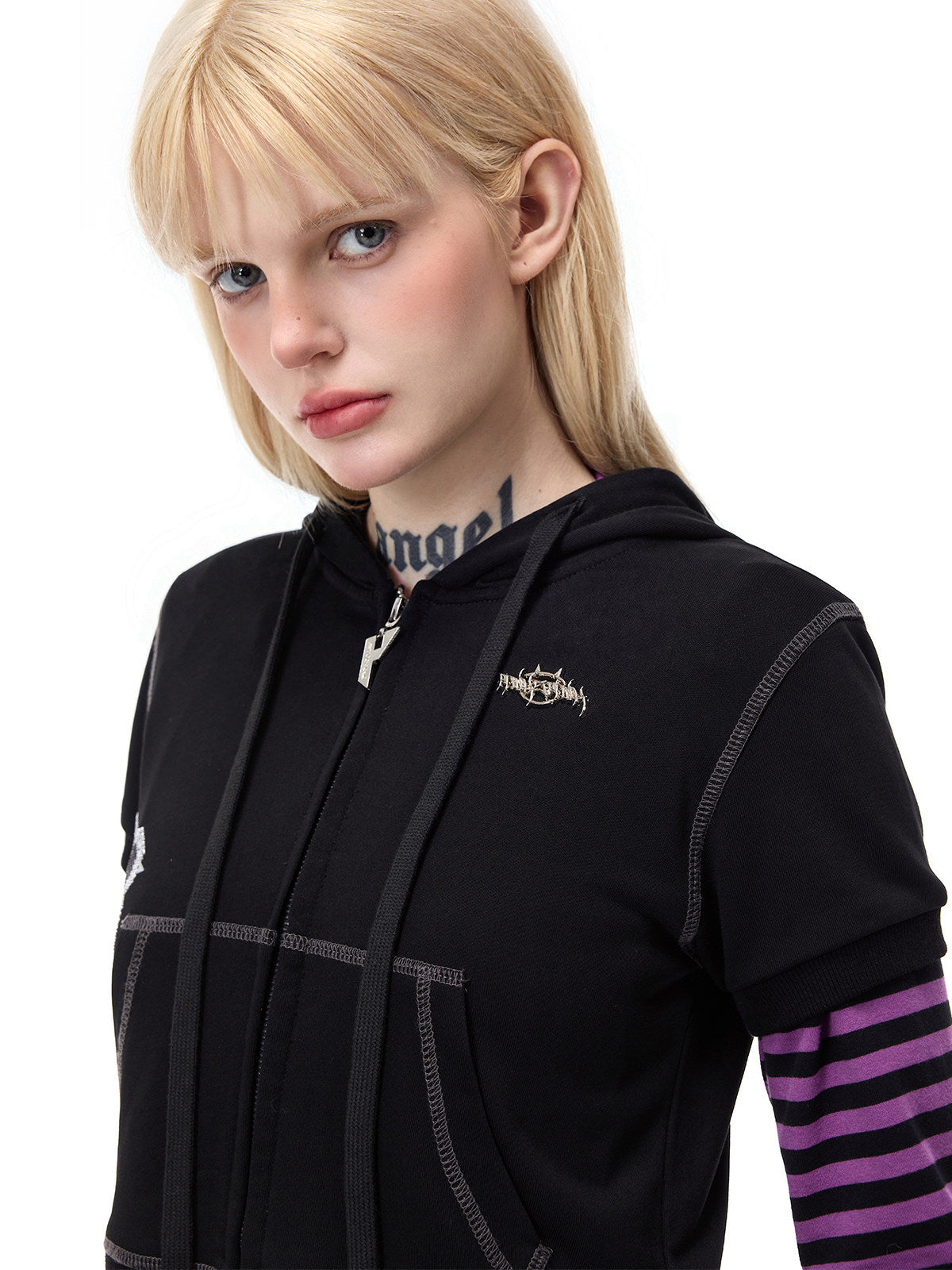 PINKSPINK CATPAW cropped cat-ear zip hoodie in black — chest close-up showing metal brand badge, drawstrings and contrast stitching