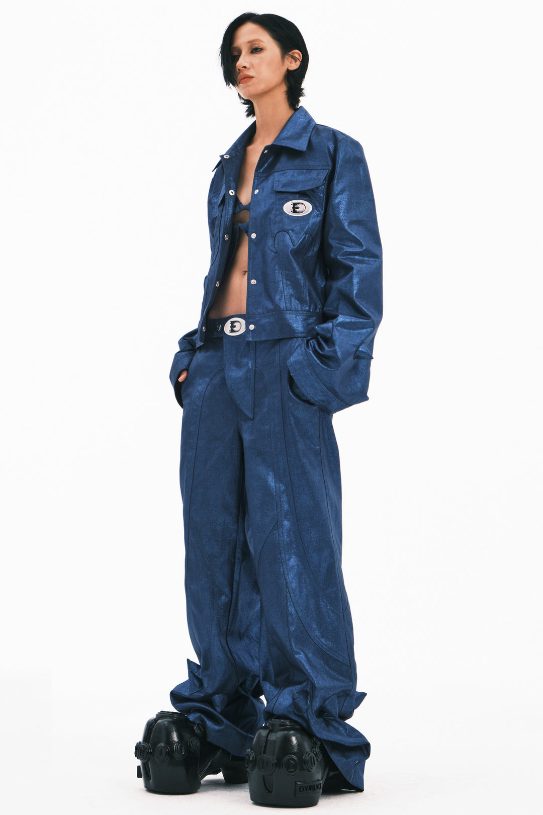 EMBRYO BLUE SPIKE metallic bell-sleeve jacket — blue three-quarter modeled view with jacket open and hands in pockets