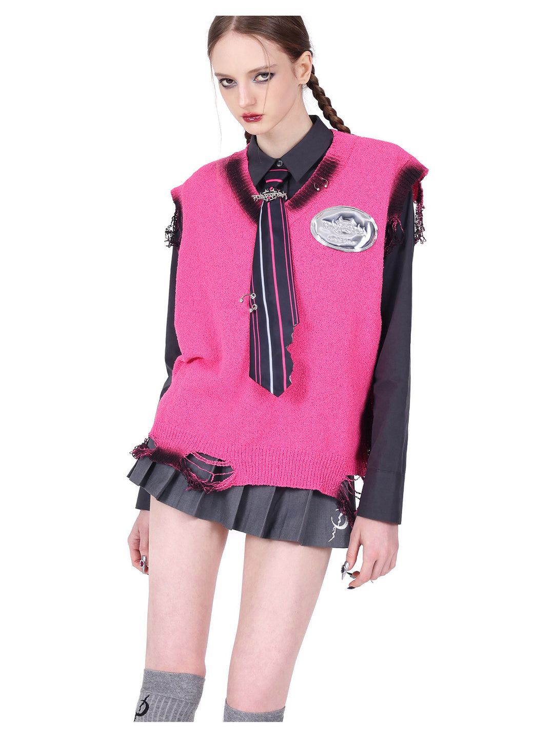 PINKSPINK REBEL distressed ring-detail knit vest in pink — angled front modeled detail layered with a separate dark shirt and striped tie