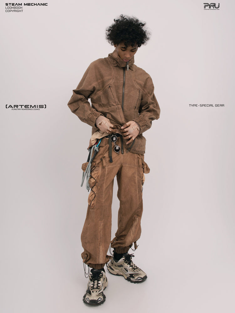ARTEMIS soft dawn orange tuck-paneled technical jacket — full-length front modeled view adjusting the hem
