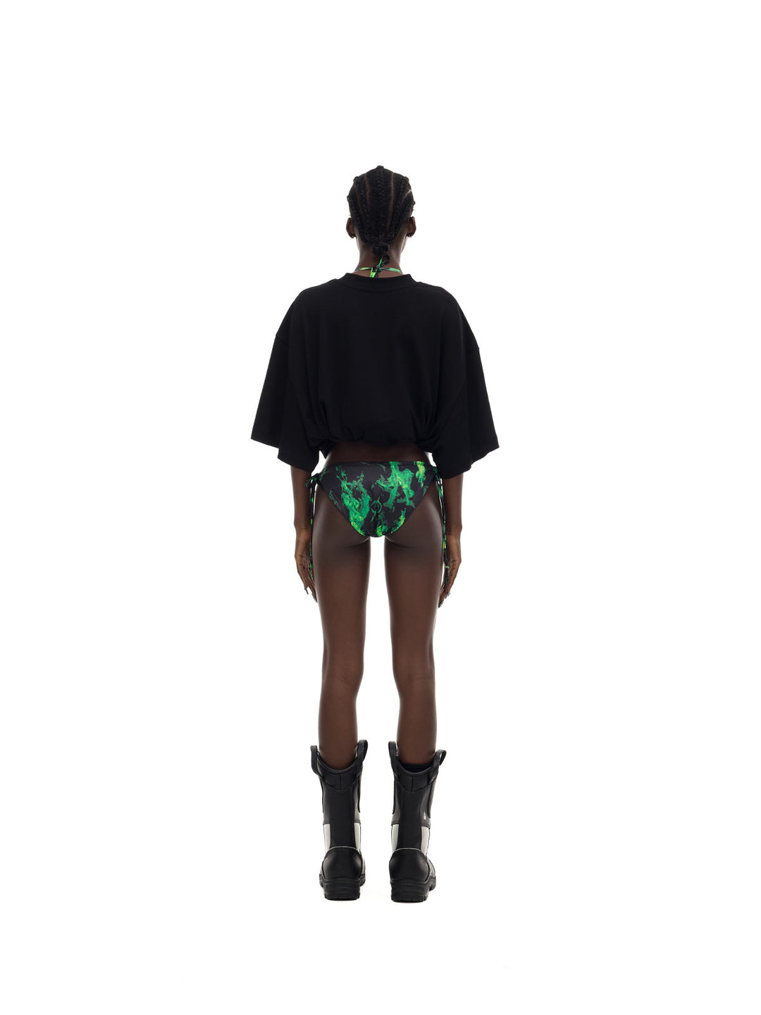 PINKSPINK MONSTER cat-skeleton oversized graphic tee in black — full-length rear modeled view with the hem rolled up over separate printed bottoms