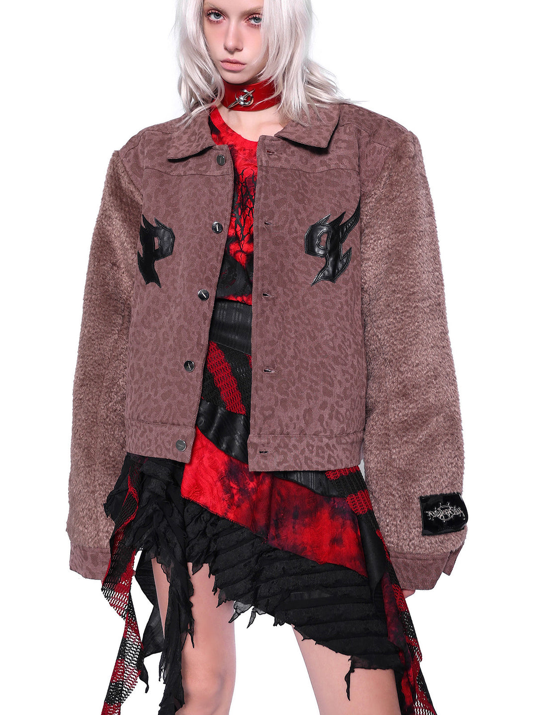 PINKSPINK ELECTRIC MOON layered striped mesh mini skirt — black and red — close modeled view styled with a brown jacket