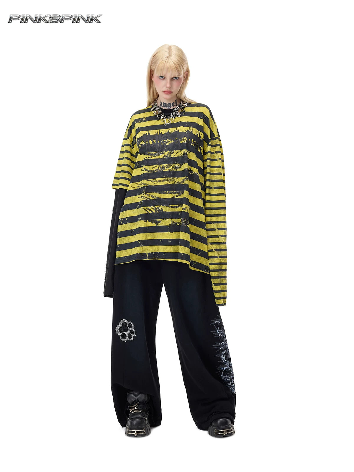 PINKSPINK STATIC asymmetric striped burnout long-sleeve tee in black and yellow — full-length front modeled view over separate black wide-leg trousers
