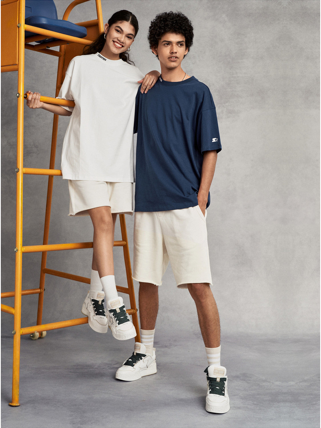 STARTER VOL-II White sneakers styled in a full-body studio look, showing their padded low-top silhouette and molded platform soles
