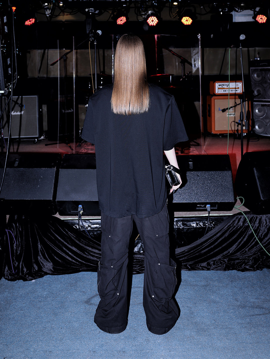 PINKSPINK METAL LOGO padded-shoulder oversized tee — modeled detail view of the garment construction