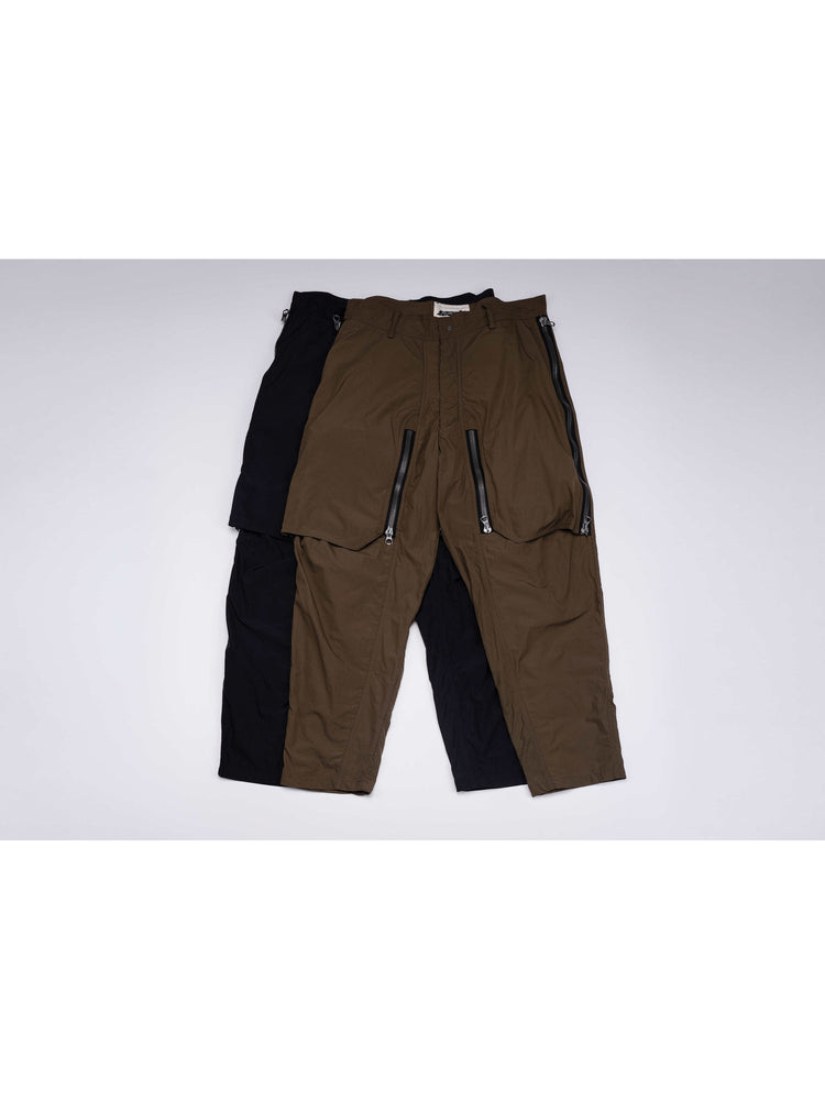 GAIA curved-blade technical pants — garment-only comparison of black and mountain green colorways