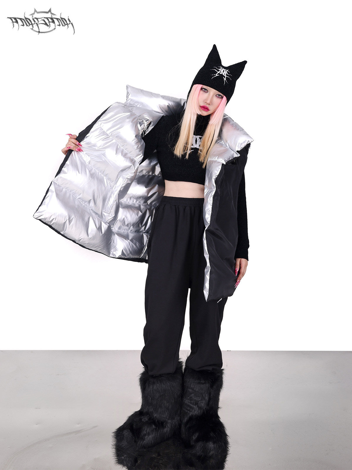 PINKSPINK ORBIT reversible padded vest in black silver — black-side modeled view held open to reveal the silver reverse
