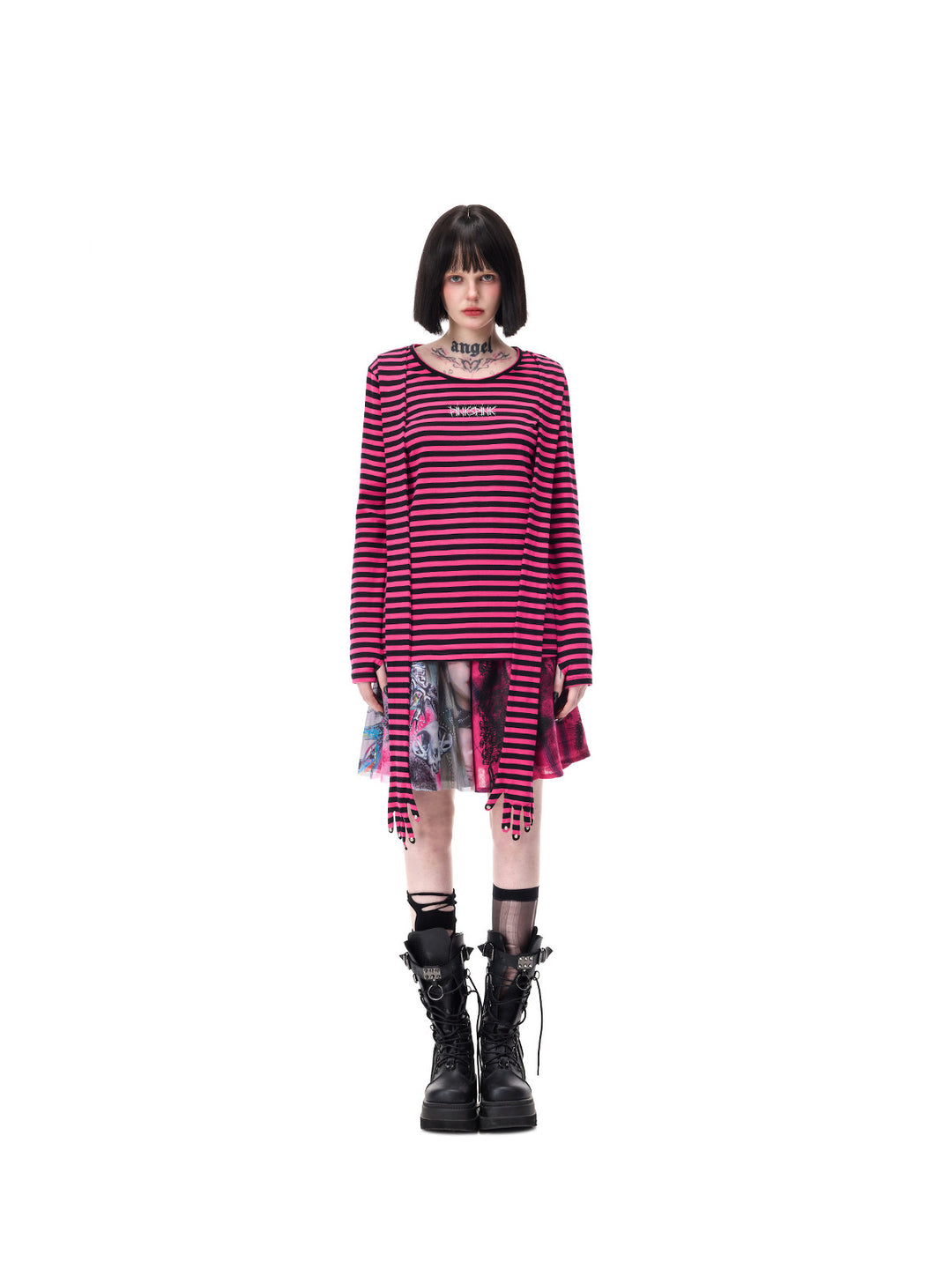 PINKSPINK FUTURE PORTRAIT reversible graphic mini skirt in black and pink — full-length front modeled view of the portrait panel beneath a separate long-sleeve striped top