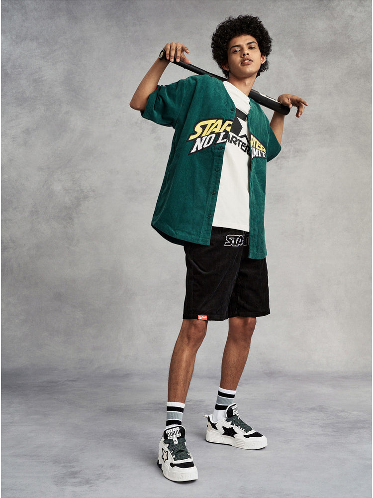 STARTER VOL-II Black White layered-star platform sneakers worn with a green jersey and black shorts, full-body studio view
