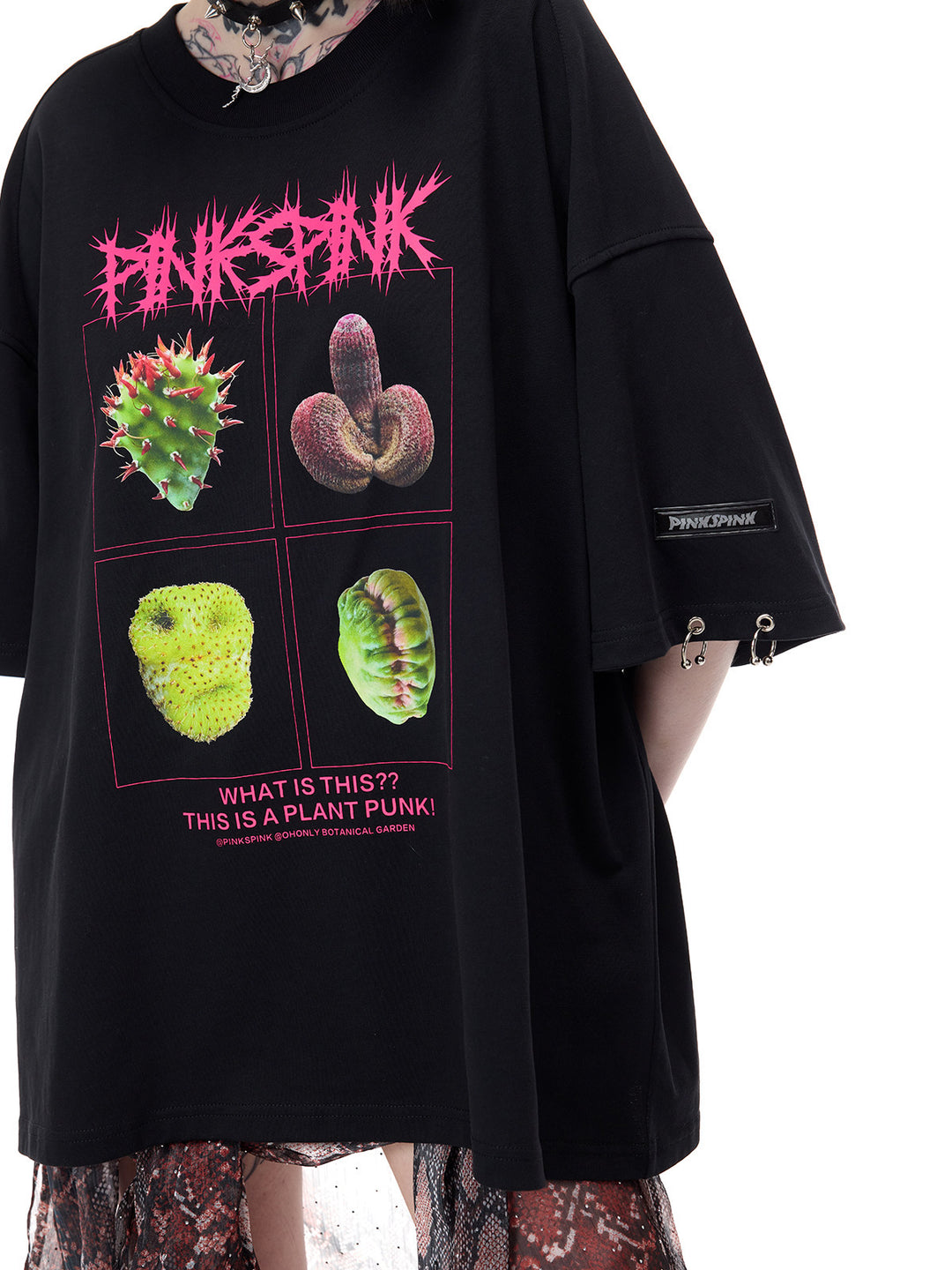 PINKSPINK PLANT PUNK oversized graphic tee in black — close front view of the four-panel botanical print and silver-tone cuff rings