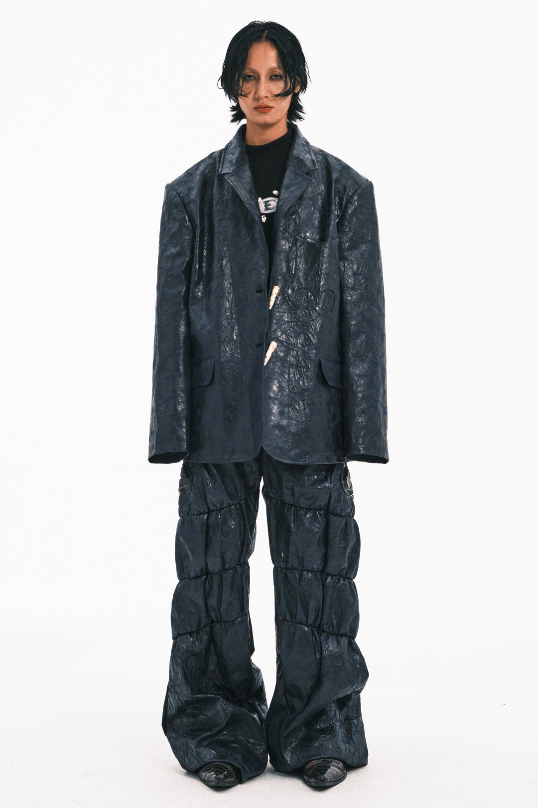 EMBRYO GUARD SHELL ruched PU leather flare pants — full-length modeled styling view