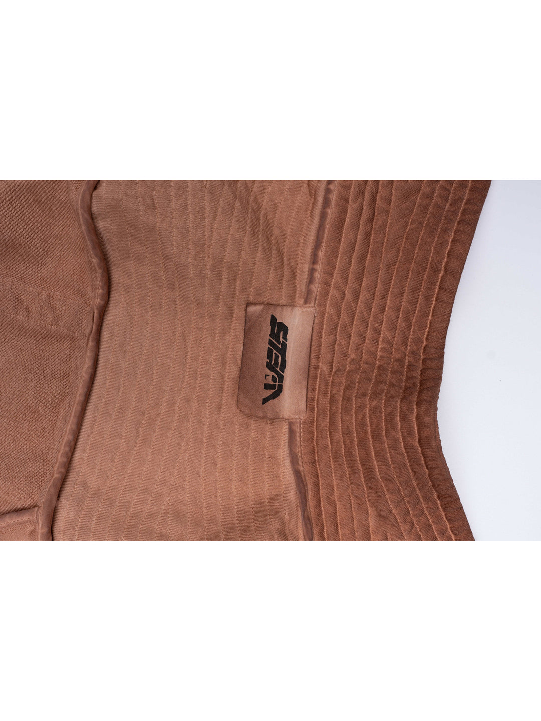 PIONEER venus orange distressed protection zip jacket — close-up of the sewn STEAM brand label beside parallel pleats