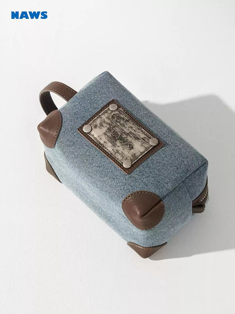 NAWS BLUE BOX denim makeup bag — alternate modeled view showing the silhouette