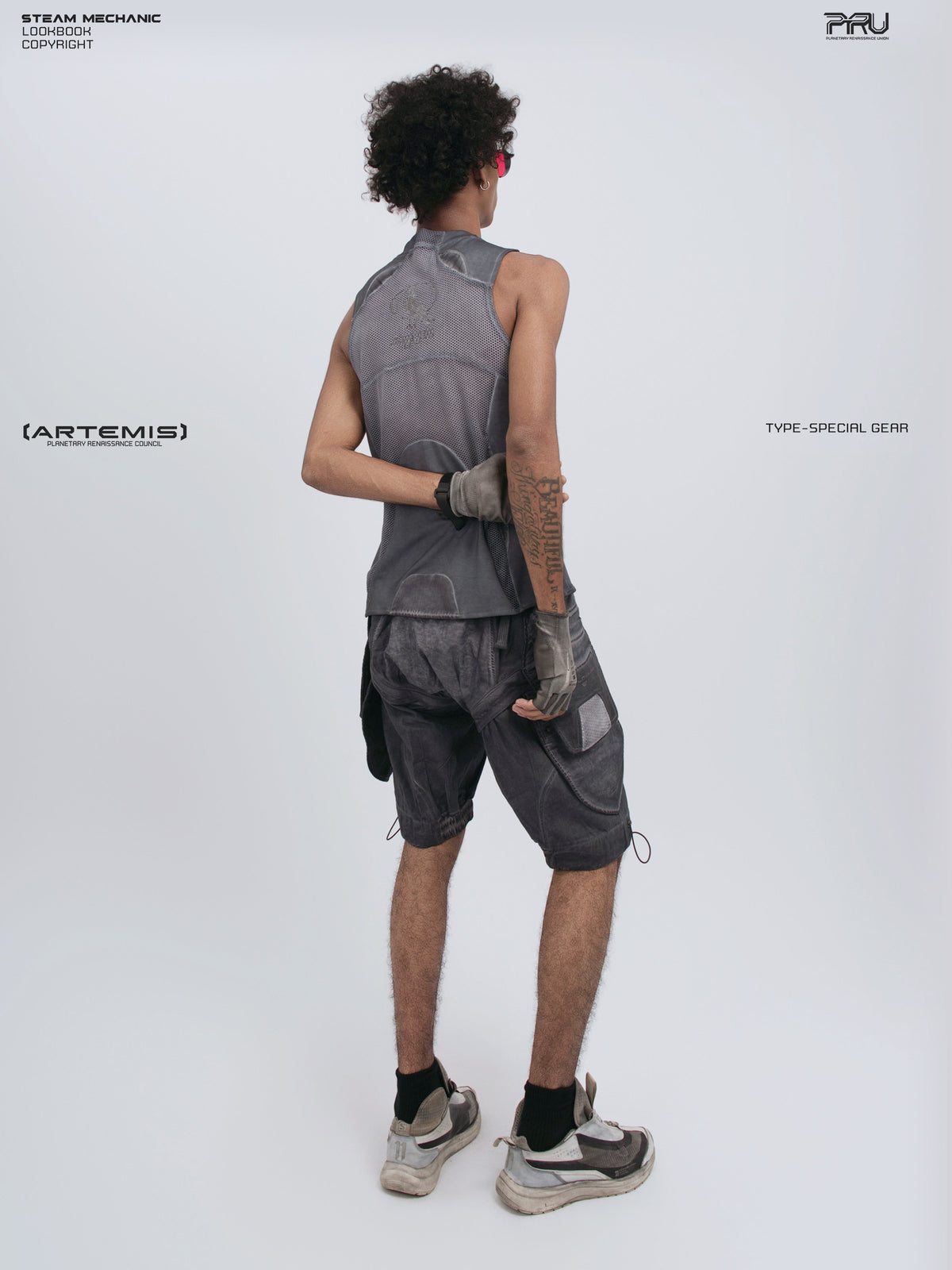 AEGIS stellar blue distressed mesh tank — three-quarter back modeled view with one arm behind the waist