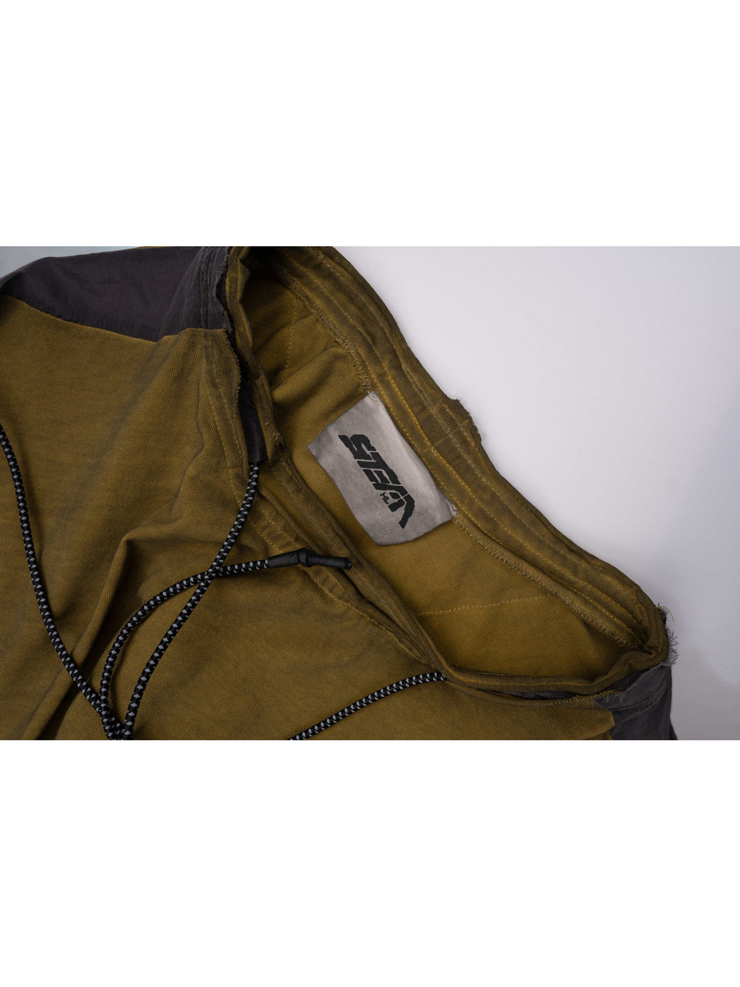 PIONEER mars yellow drawstring commuter sweatshirt — close-up of the neckline, drawcord and sewn STEAM brand label