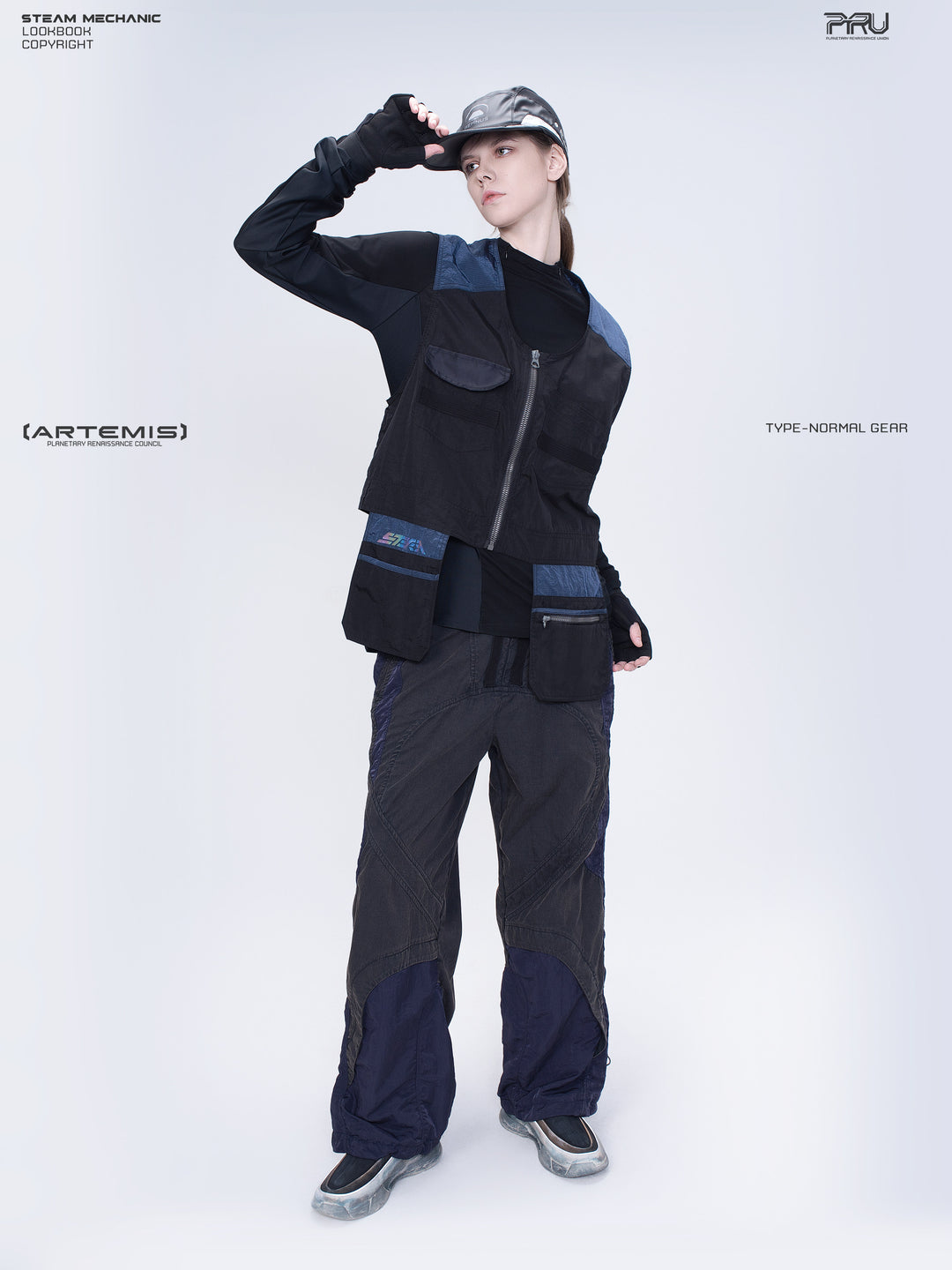 SUPERNOVA zima blue metallic nylon technical pants — full-length modeled front view with hand at the cap brim