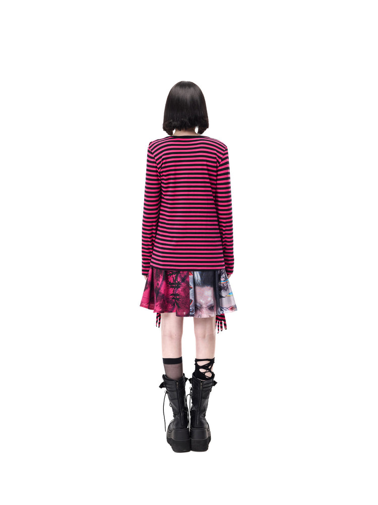PINKSPINK FUTURE PORTRAIT reversible graphic mini skirt in black and pink — full-length rear modeled view showing the plaid and portrait panels beneath a separate striped top