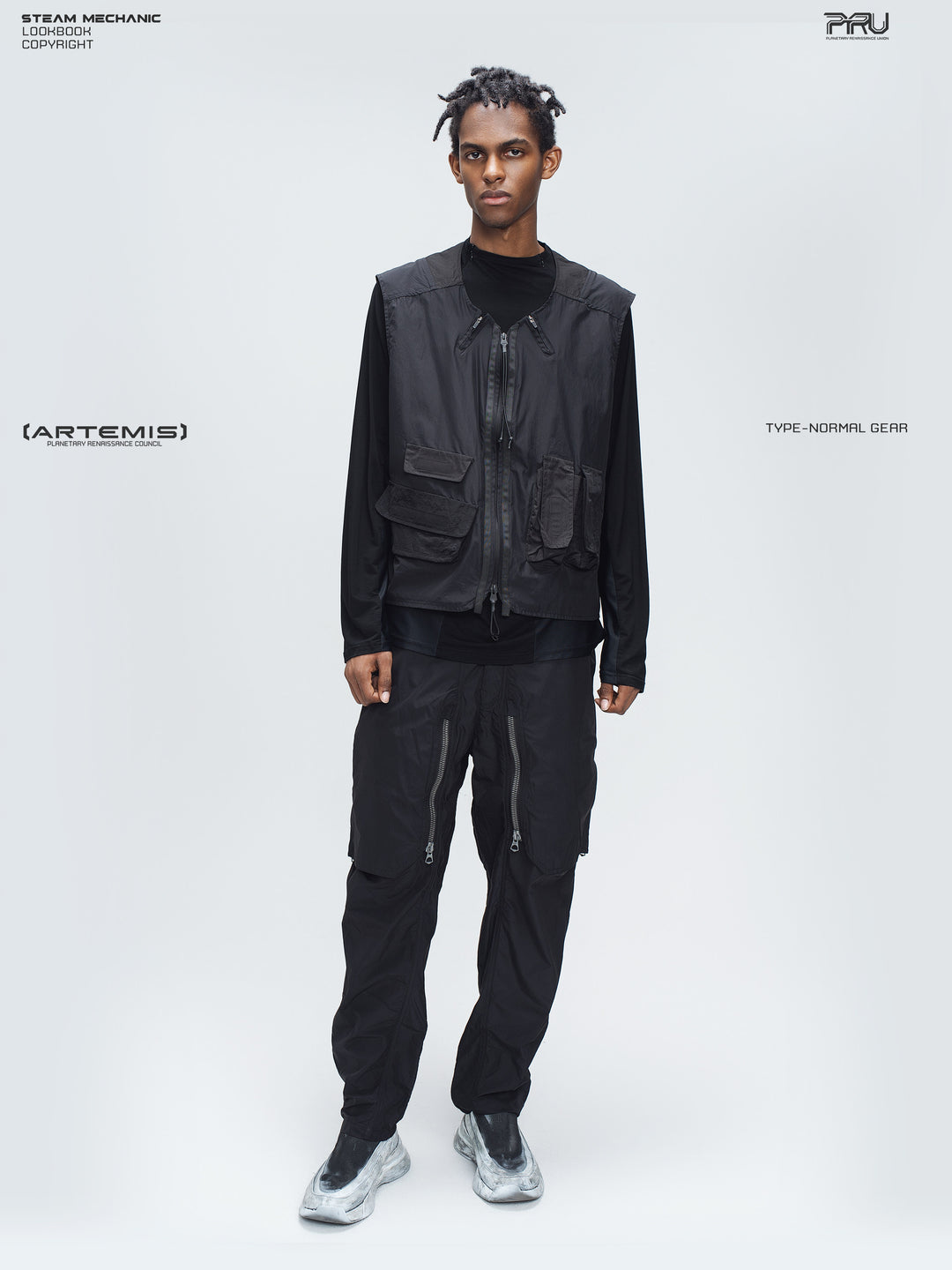 GAIA curved-blade technical pants in black — full-length front styling view with a matching utility vest