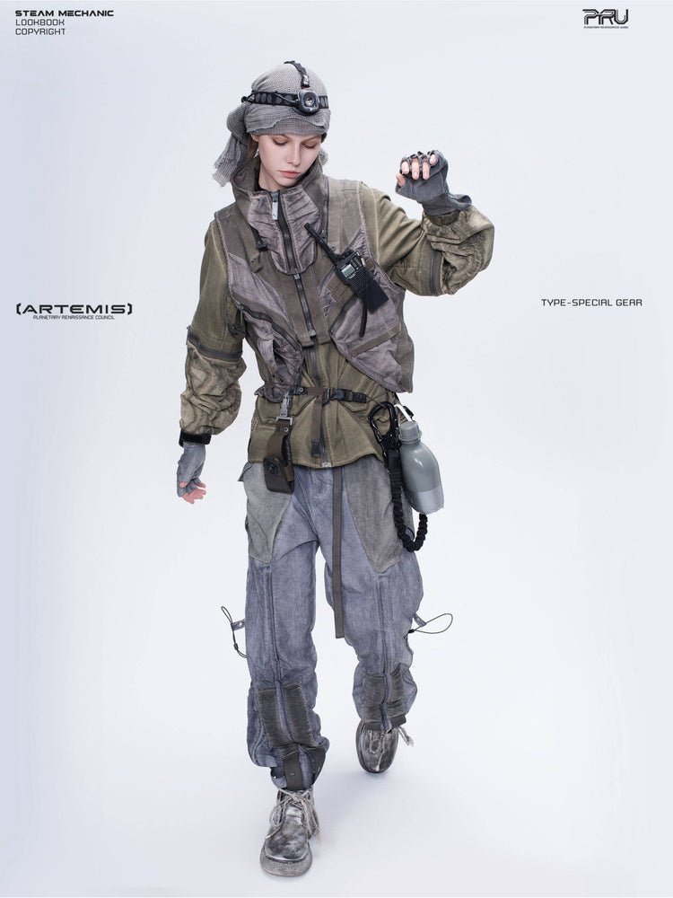 FISSION modular vest in mercury brown — full-length modeled view on a woman with one hand raised