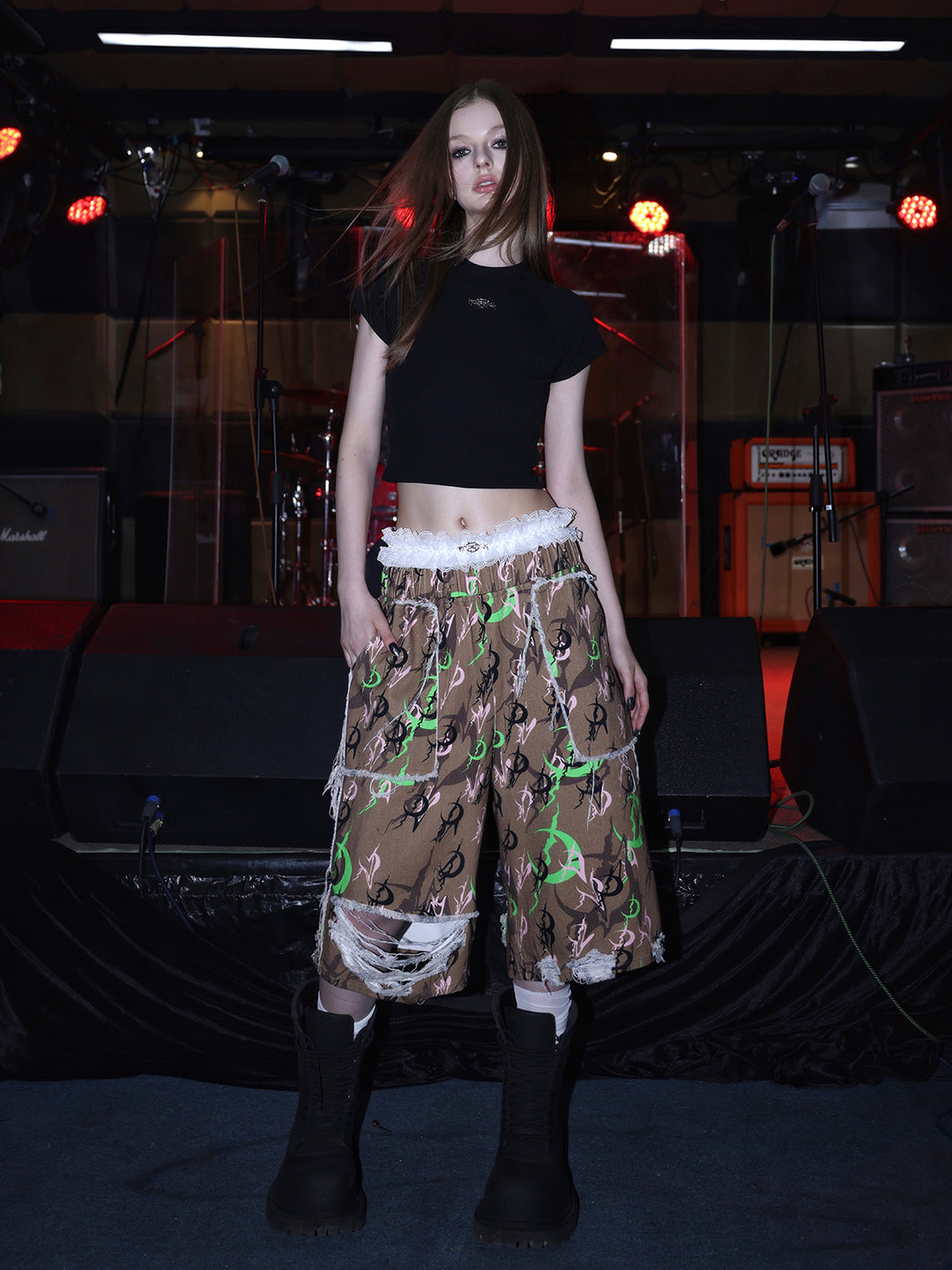 PINKSPINK ELECTRIC MOON distressed camo cropped trousers in CAMOUFLAGE — full front with black crop tee.