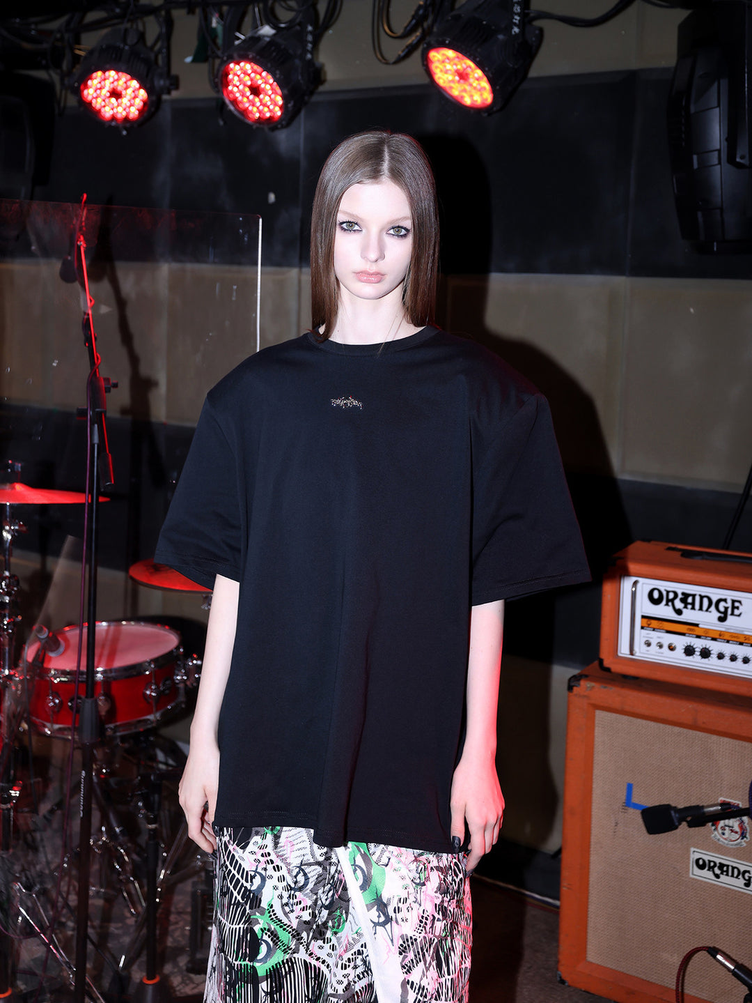 PINKSPINK METAL LOGO padded-shoulder oversized tee — close-up view of the material and finishing
