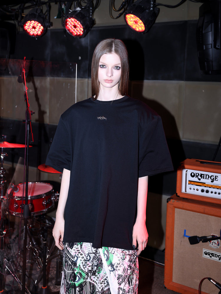 PINKSPINK METAL LOGO padded-shoulder oversized tee — close-up view of the material and finishing