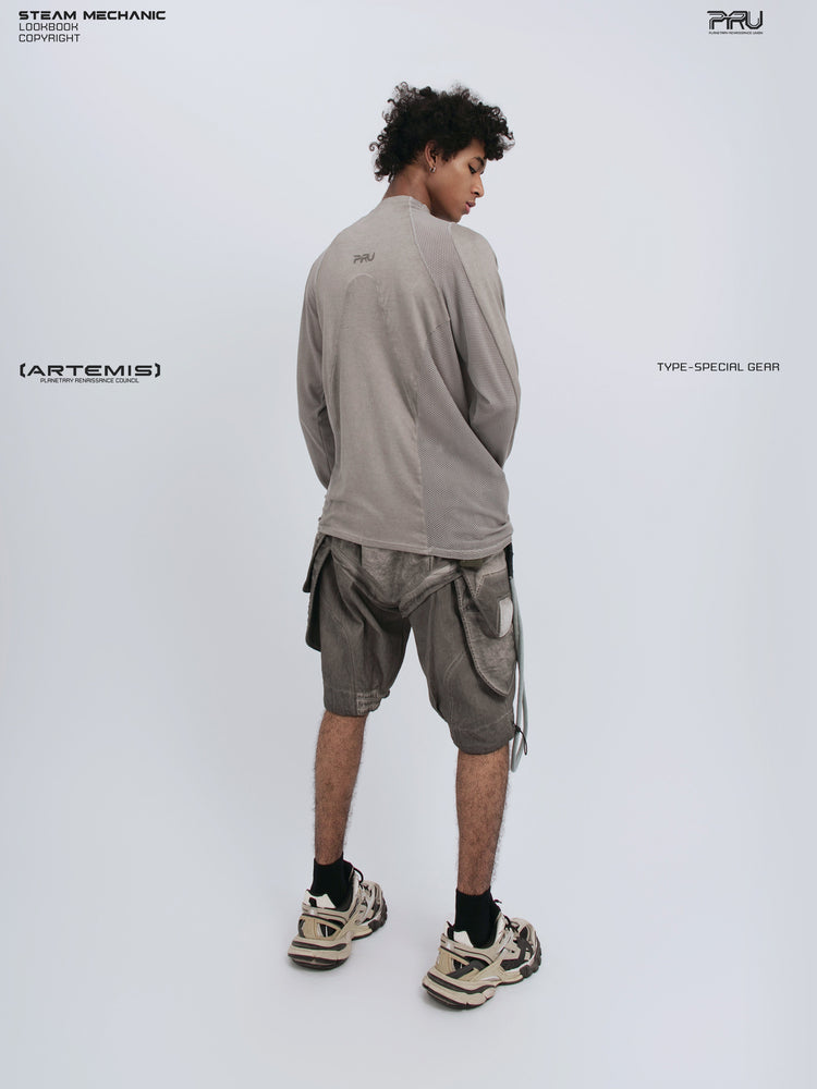 STARCORE mesh-panel long-sleeve top — full-length rear three-quarter view looking over the right shoulder
