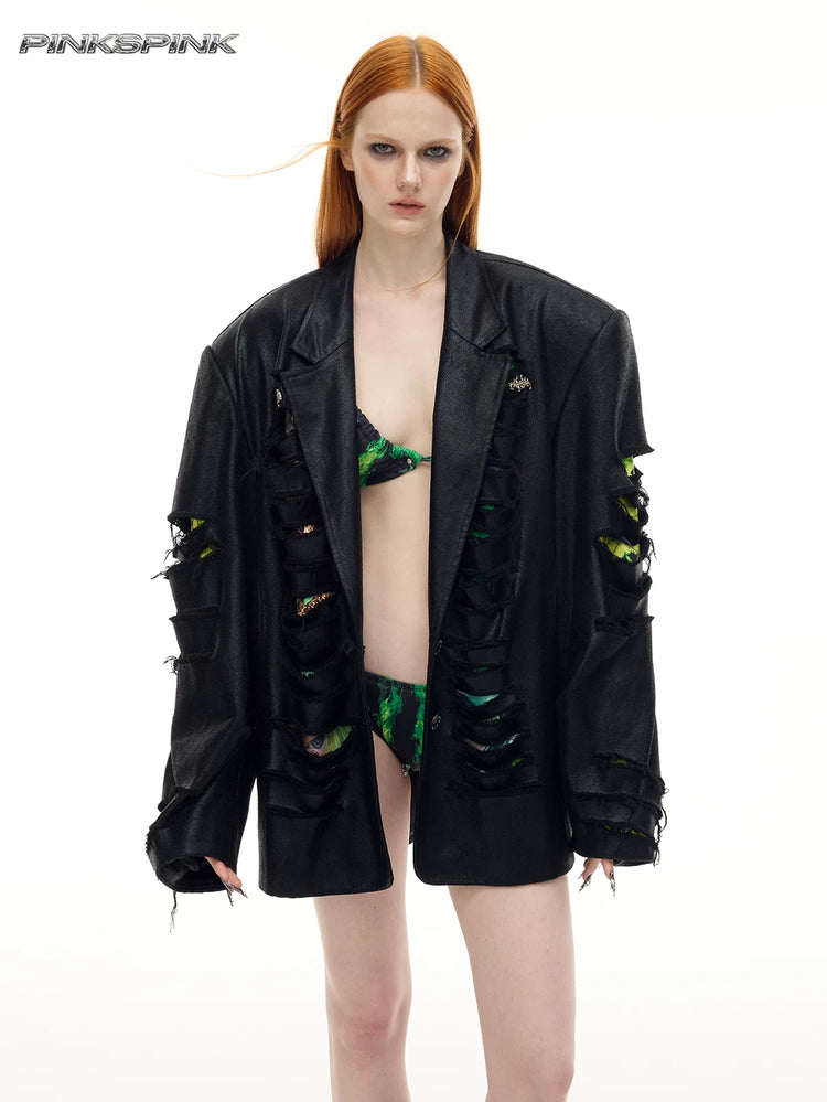 PINKSPINK BREACH distressed coated oversized blazer in black — front modeled view worn open, showing the lapels and slashed sleeves