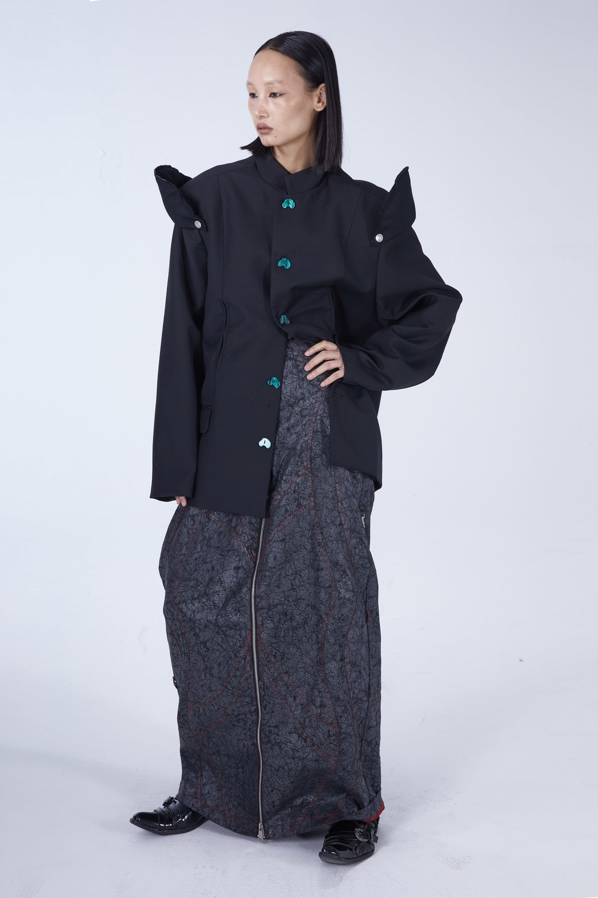 EMBRYO IMPERIAL GUARD detachable-shoulder Zhongshan blazer in black — full-length three-quarter modeled view with one hand at the waist