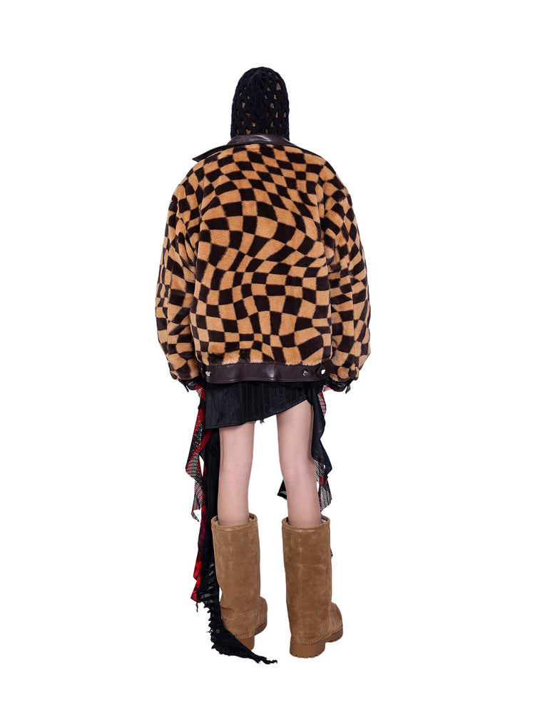 PINKSPINK WARPED checkerboard padded faux-fur jacket — caramel brown checkerboard jacket — back view over a black hooded layer
