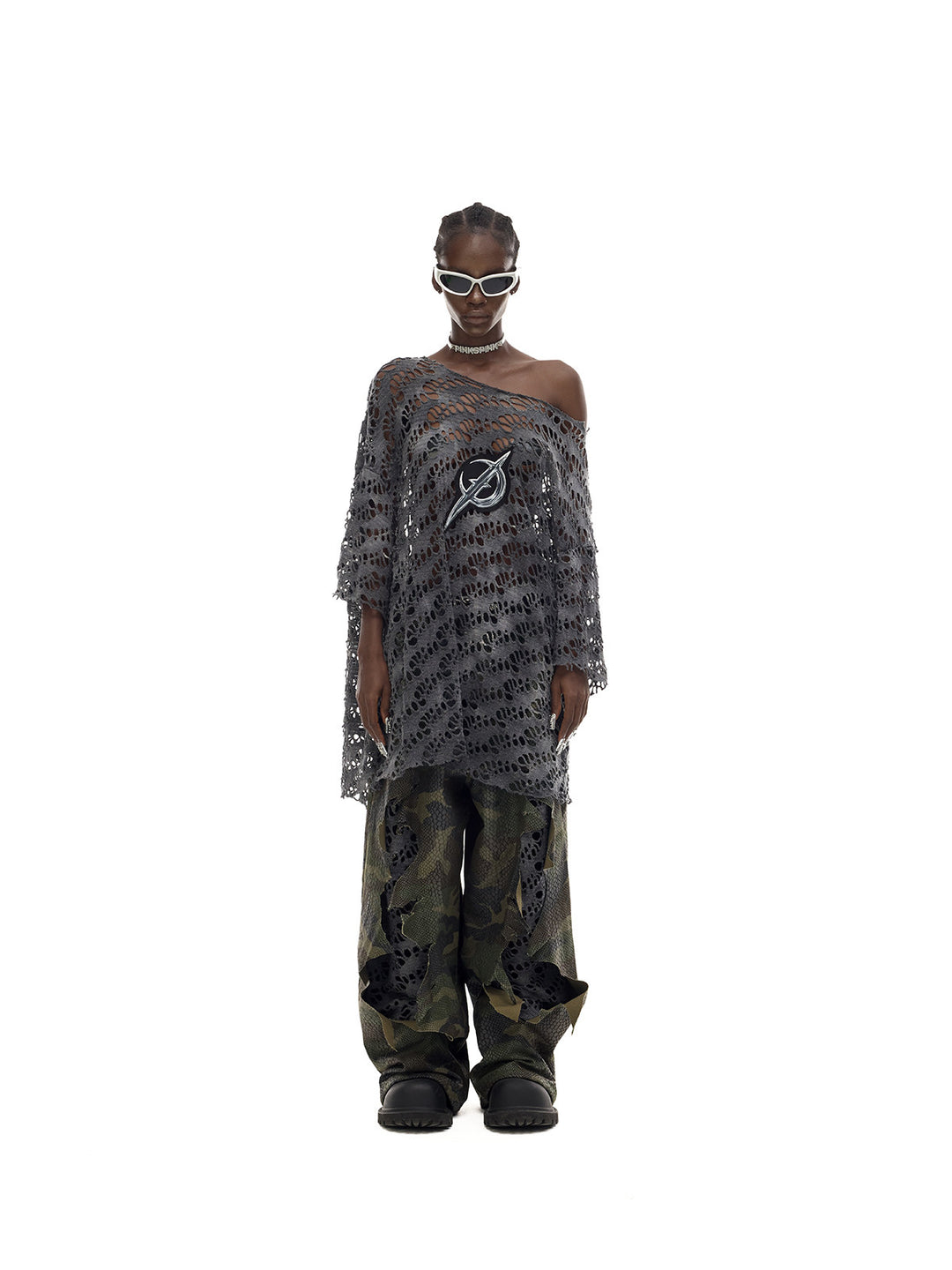 PINKSPINK ELECTRIC MOON distressed open-knit oversized tee in charcoal gray — full-length front modeled view with camouflage trousers