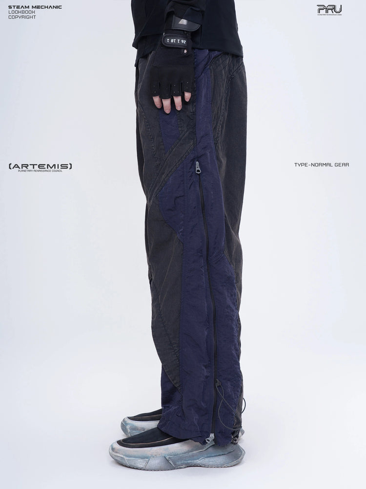 SUPERNOVA zima blue metallic nylon technical pants — side modeled close-up showing zip pocket and hem
