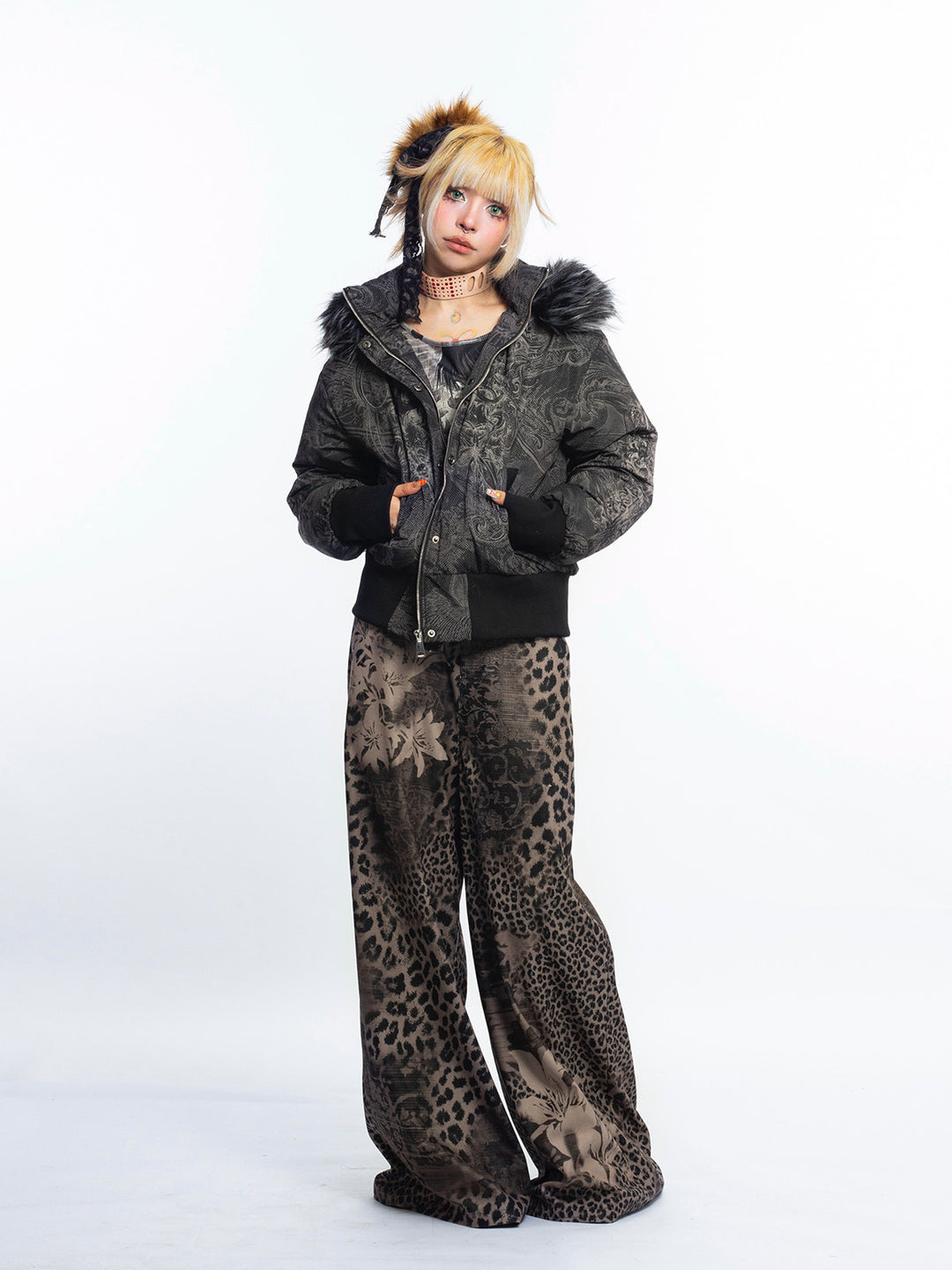 4RE1GN GOTHIC down jacket in charcoal ornamental print — Full-body modeled view with jacket partly open and patterned flared trousers.
