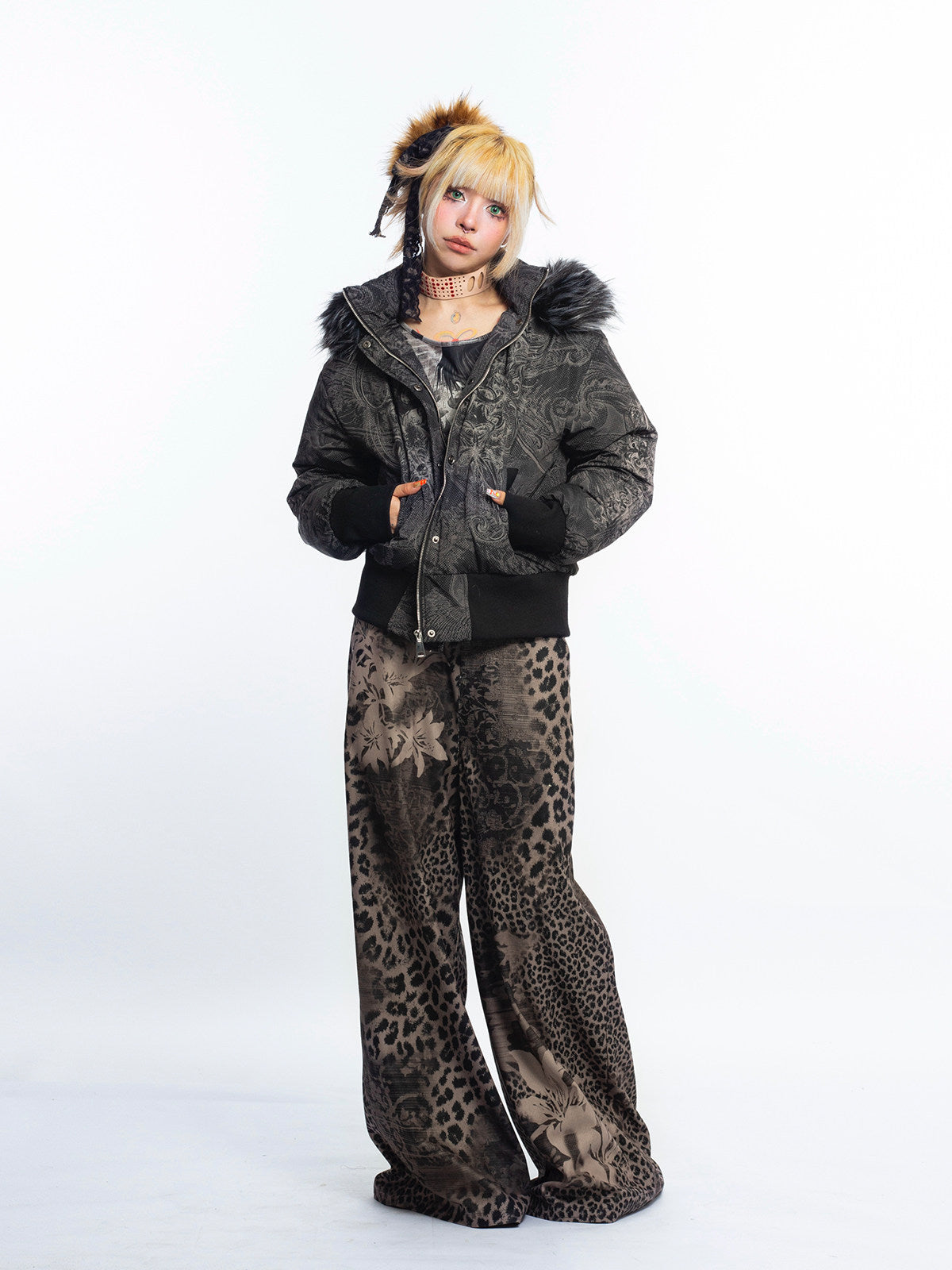 4RE1GN GOTHIC down jacket in charcoal ornamental print — Full-body modeled view with jacket partly open and patterned flared trousers.