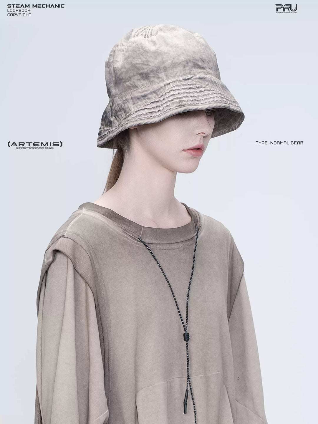 PIONEER mercury brown distressed nylon bucket hat — three-quarter portrait showing the washed nylon texture