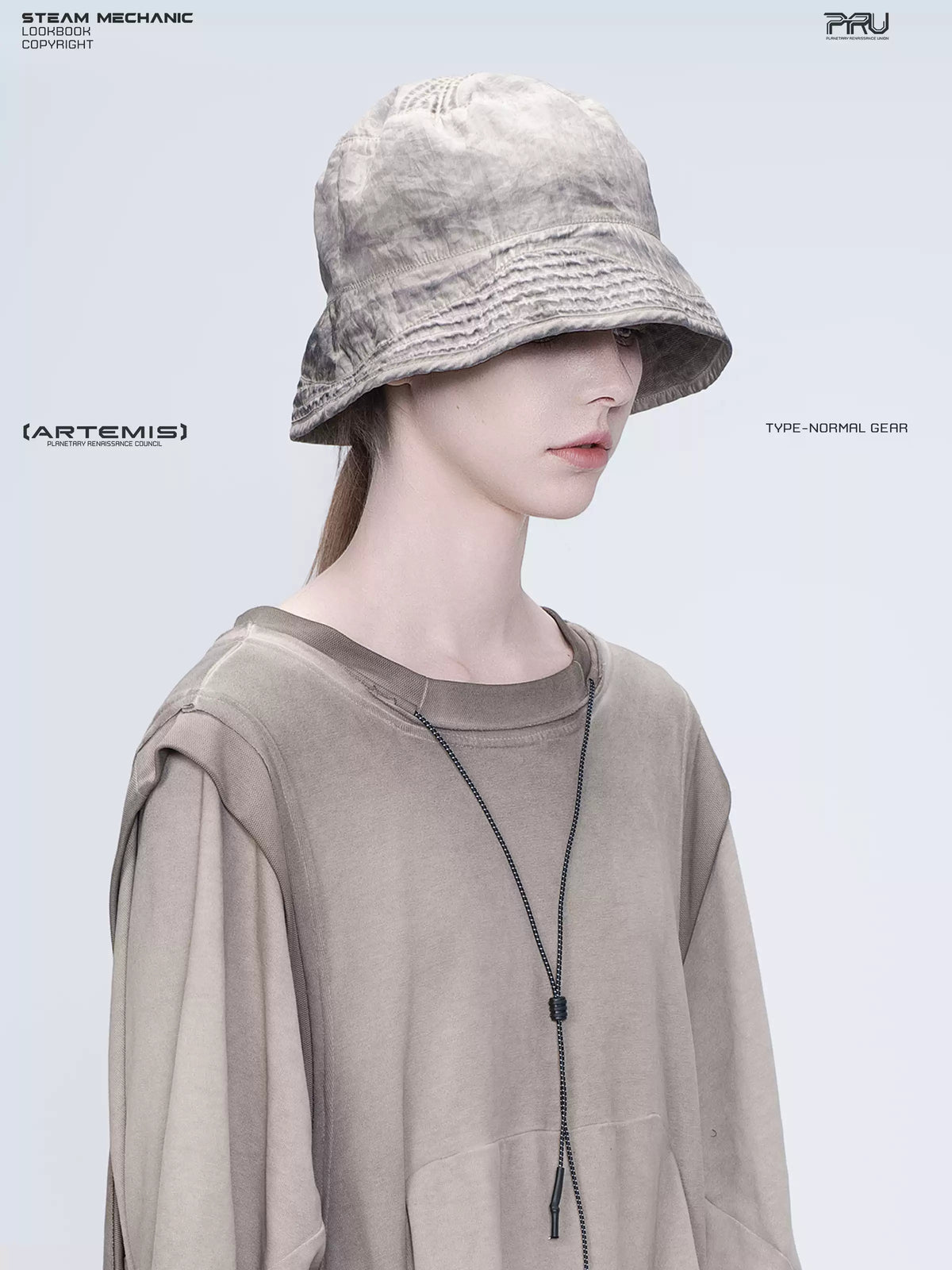 PIONEER mercury brown distressed nylon bucket hat — three-quarter portrait showing the washed nylon texture
