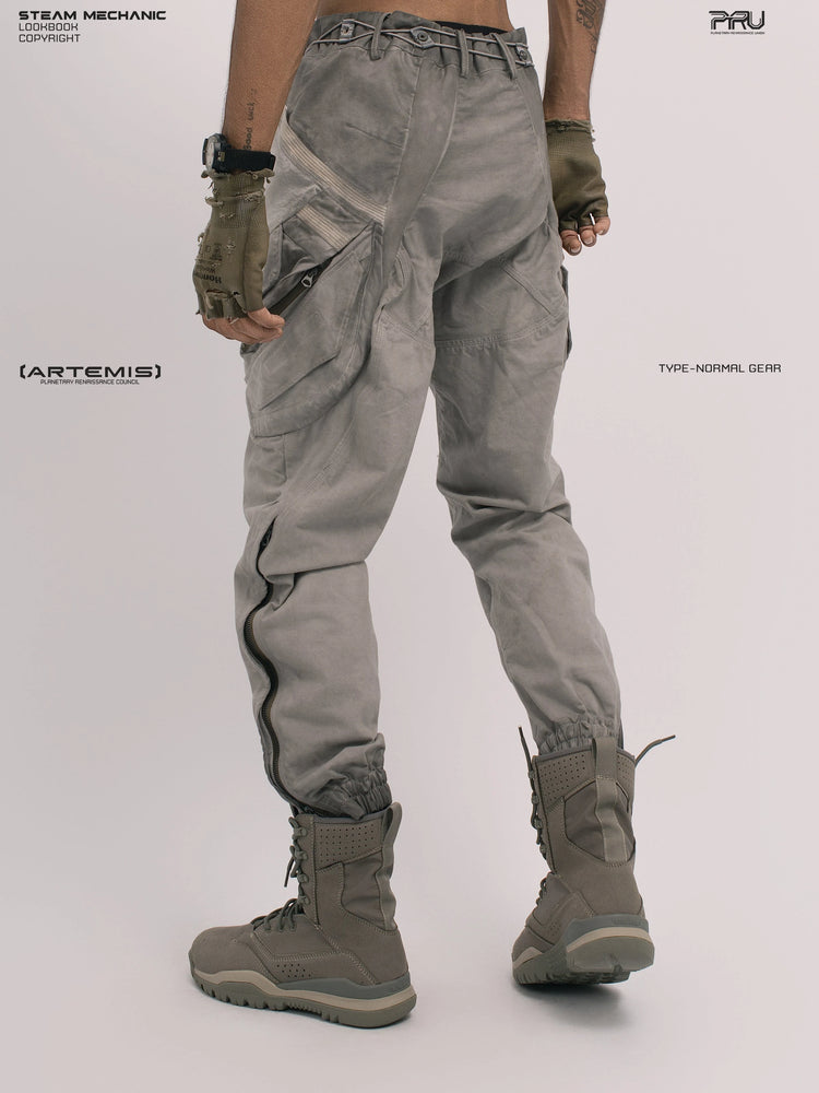 AEGIS lunar sea gray multi-pocket moto pants — rear three-quarter modeled view with one heel raised