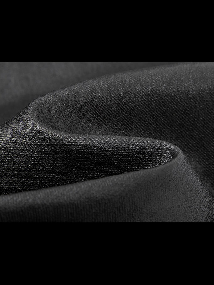NAWS wax-coated zip-hem jeans in black — close-up of the denim fabric texture.