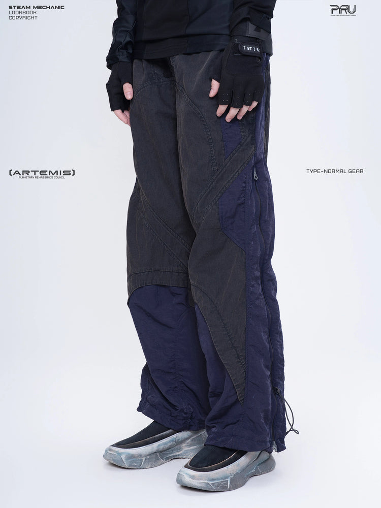 SUPERNOVA zima blue metallic nylon technical pants — three-quarter front modeled close-up facing left