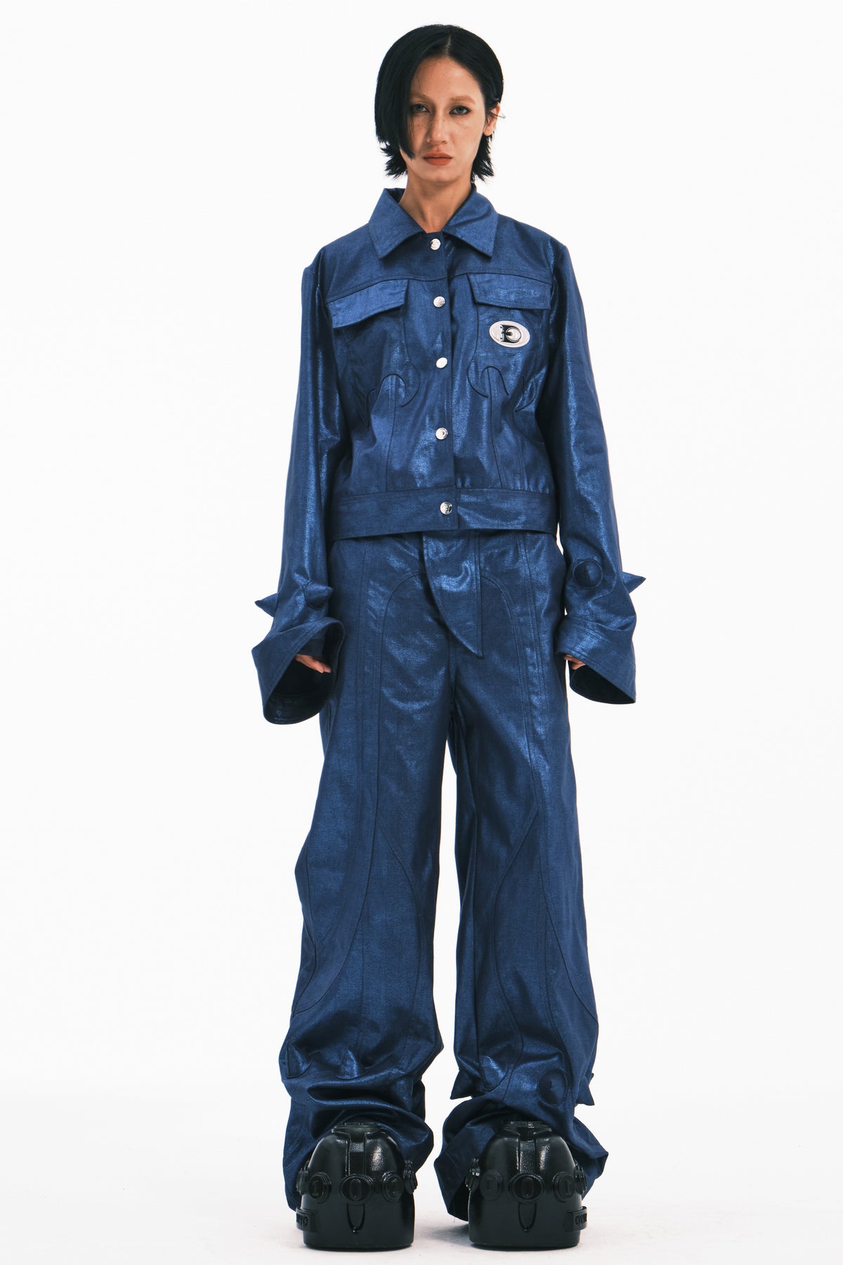 EMBRYO BLUE SPIKE metallic bell-sleeve jacket — blue full-length front modeled view with jacket buttoned and arms down