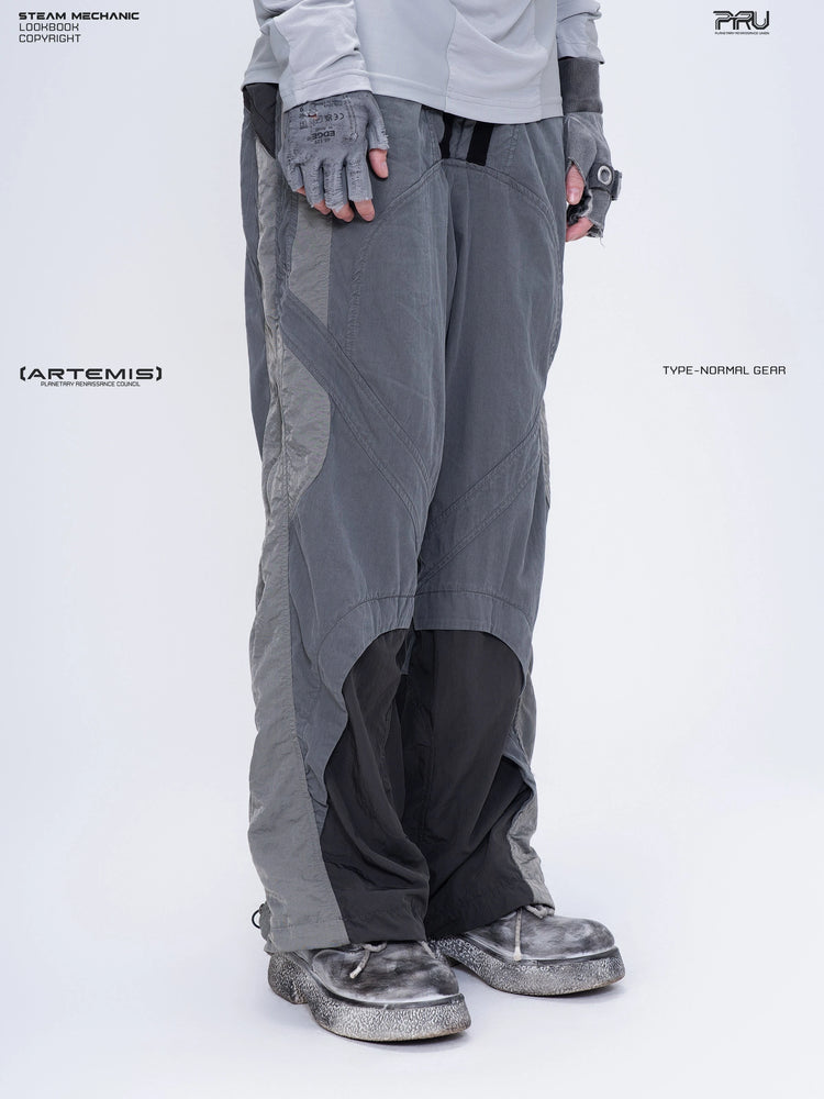 SUPERNOVA alloy gray metallic nylon technical pants — three-quarter front modeled close-up facing right