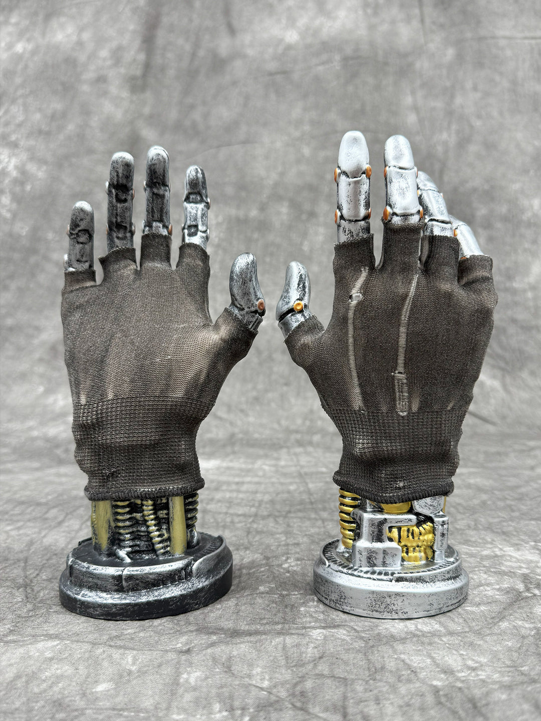 PRECISION CASTING distressed fingerless gloves in brown soil, NO GLUE — retired uncoated configuration shown from palm and back on display hands