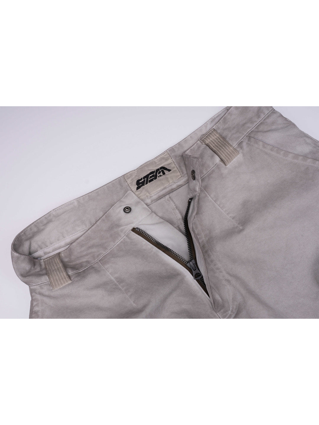 PIONEER eris white welded multi-pocket work pants — waistband detail showing belt loops, snap closure, zipper fly and STEAM label